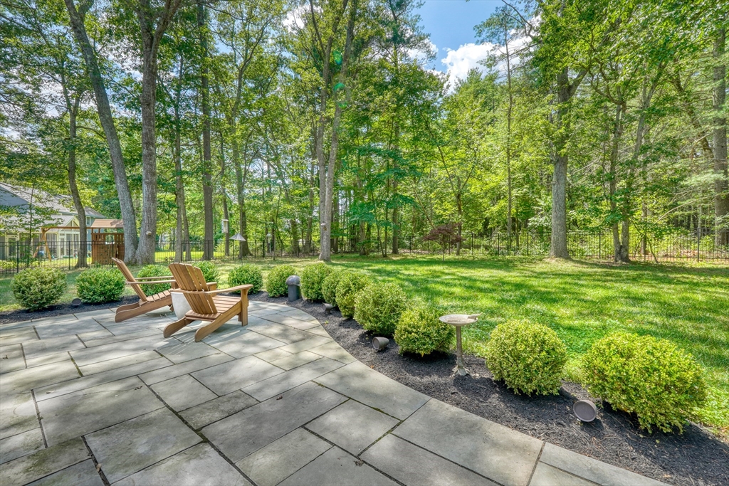 162 Border Road Concord, MA 01742 - Photo 35 of 39 a view of a backyard with table and chairs and garden