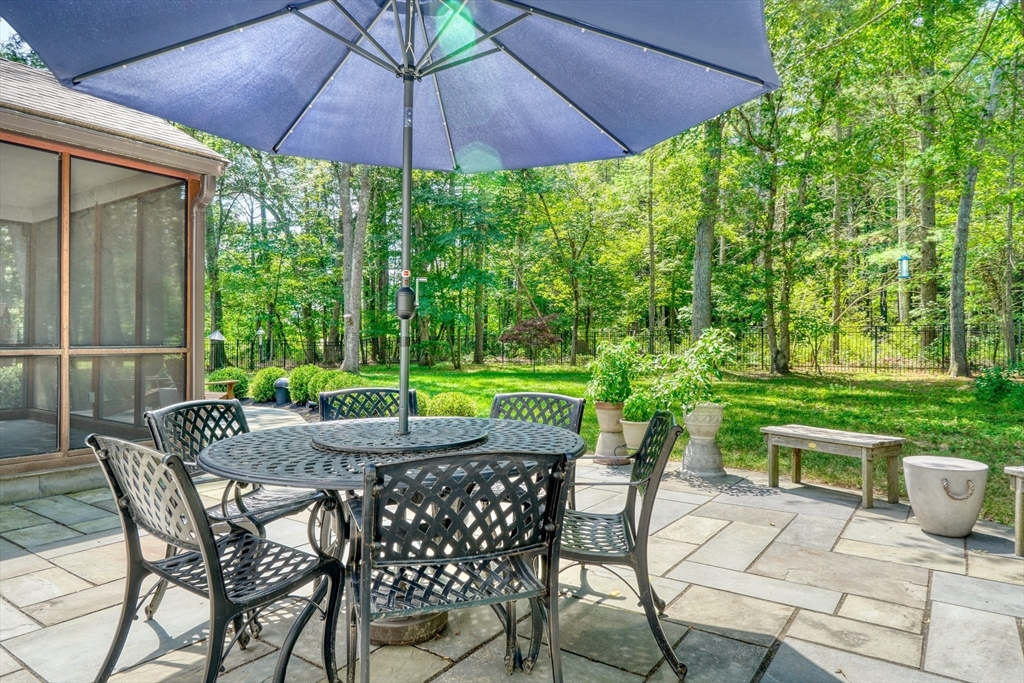 162 Border Road Concord, MA 01742 - Photo 37 of 39 a view of an outdoor sitting area with furniture and umbrella