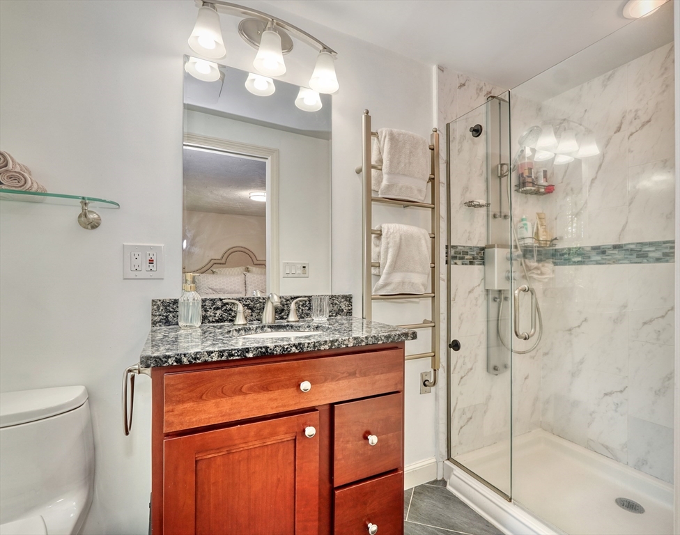162 Border Road Concord, MA 01742 - Photo 5 of 39 a bathroom with a granite countertop sink mirror and shower