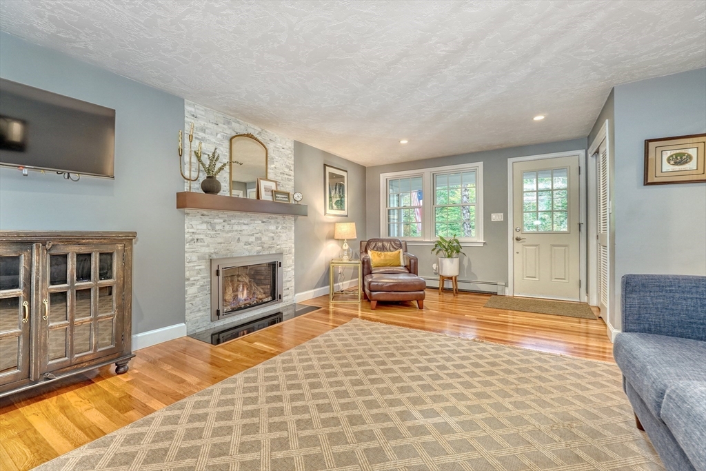 162 Border Road Concord, MA 01742 - Photo 7 of 39 a living room with furniture and a fireplace