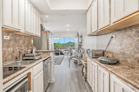a kitchen with a sink stove and cabinets