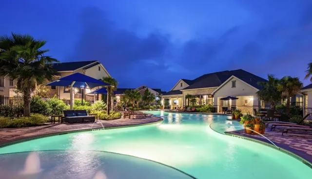 a bedroom with a bed and a lamp