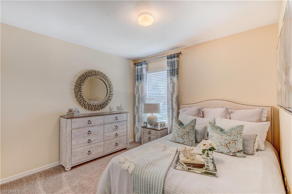 679 Hadley Place East Naples, FL 34104 - Photo 4 of 9 a bedroom with a bed and wooden floor