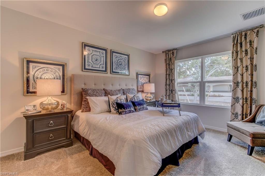 679 Hadley Place East Naples, FL 34104 - Photo 8 of 9 a large bedroom with a bed and large windows