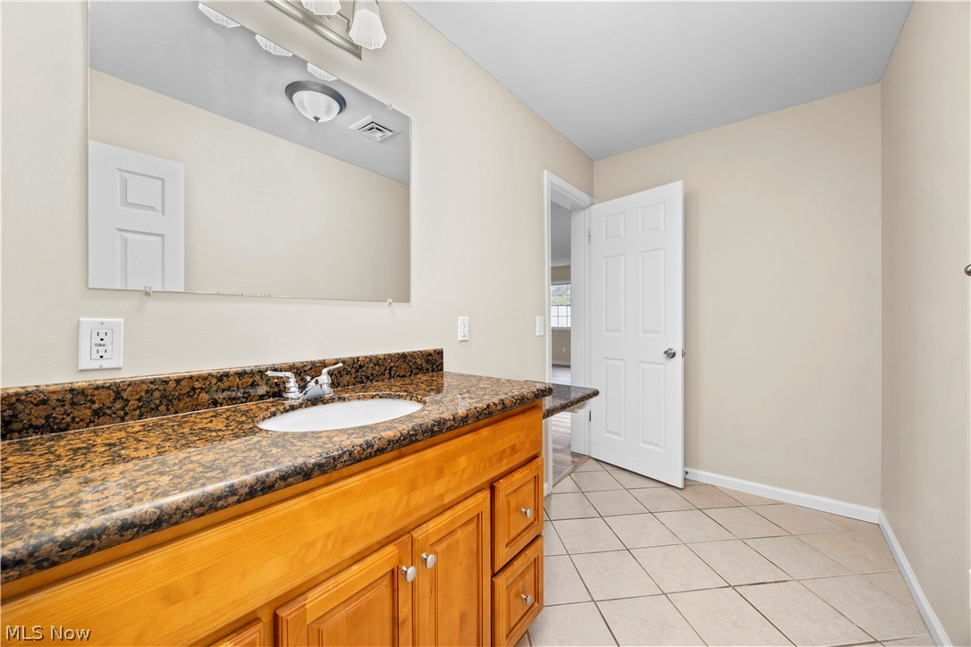 12452 Island Road Grafton, OH 44044 - Photo 27 of 39 Bathroom with vanity and light tile patterned floors