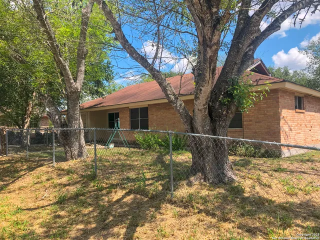 a backyard of a house with table and chairs