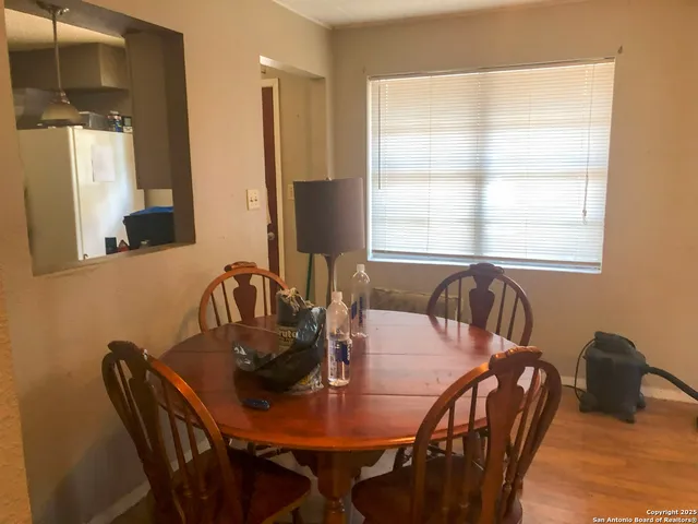 a view of a dining room with furniture and window
