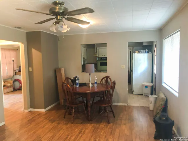 a view of a dining room with furniture and wooden floor