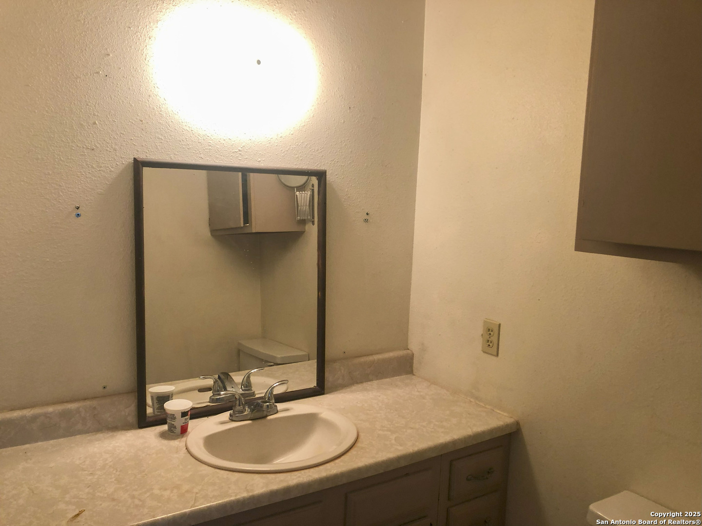 10446 5th Street Pettus, TX 78146 - Photo 8 of 16 a bathroom with a sink and a mirror