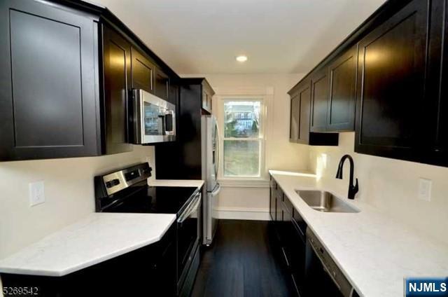 314 Cornelia Street Boonton, NJ 07005 - Photo 23 of 29 a kitchen with granite countertop a sink a stove and refrigerator