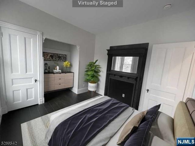 314 Cornelia Street Boonton, NJ 07005 - Photo 28 of 29 a bedroom with a bed closet and mirror