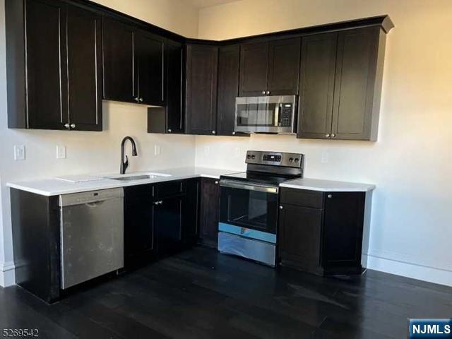 314 Cornelia Street Boonton, NJ 07005 - Photo 10 of 29 a kitchen with stainless steel appliances a sink a stove a microwave and wooden cabinets