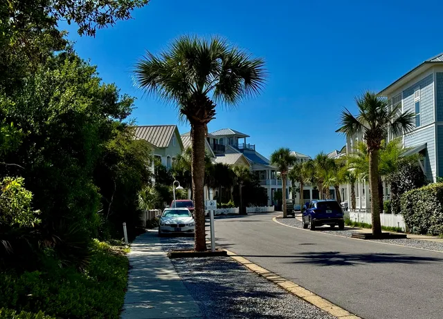a view of a patio with couches table and chairs with wooden floor and fence