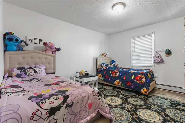 a living room with furniture a flat screen tv and a table