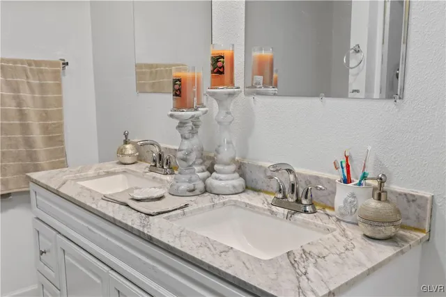 a view of a house with a big yard and large trees