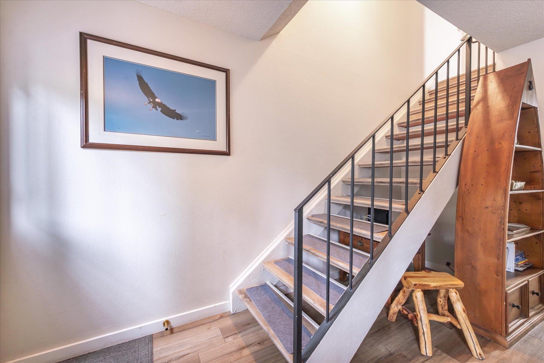 3101 Lake Forest Road, Unit 26 Tahoe City, CA 96145 - Photo 15 of 27 a view of staircase with wooden floor and white walls