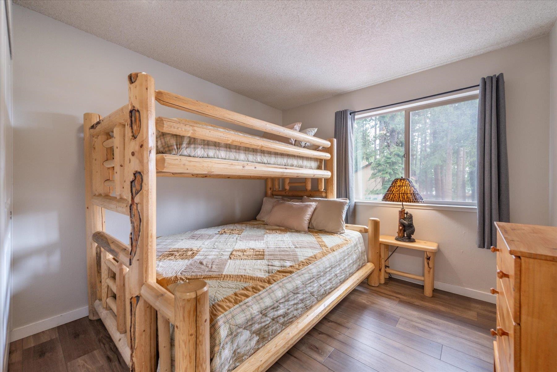 3101 Lake Forest Road, Unit 26 Tahoe City, CA 96145 - Photo 19 of 27 a bedroom with a bed and a large window