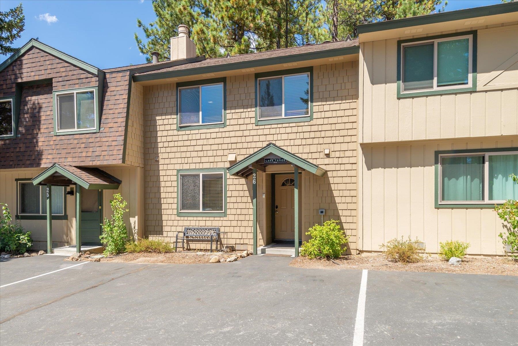 3101 Lake Forest Road, Unit 26 Tahoe City, CA 96145 - Photo 5 of 27 a front view of a house with a yard and garage