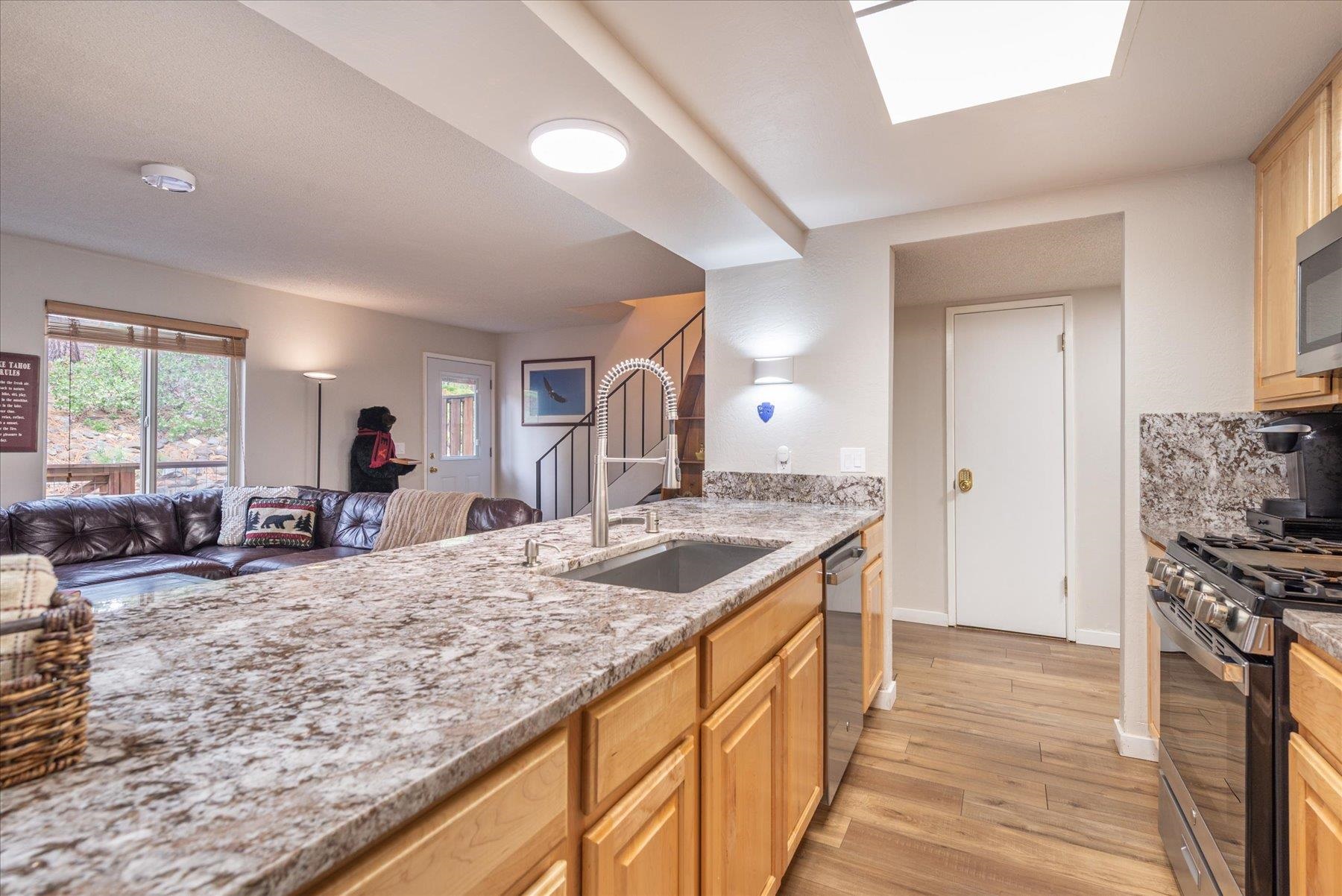 3101 Lake Forest Road, Unit 26 Tahoe City, CA 96145 - Photo 8 of 27 a kitchen with stainless steel appliances granite countertop sink stove and refrigerator