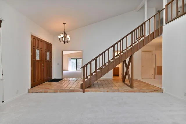 a view of a livingroom with an empty space and wooden floor