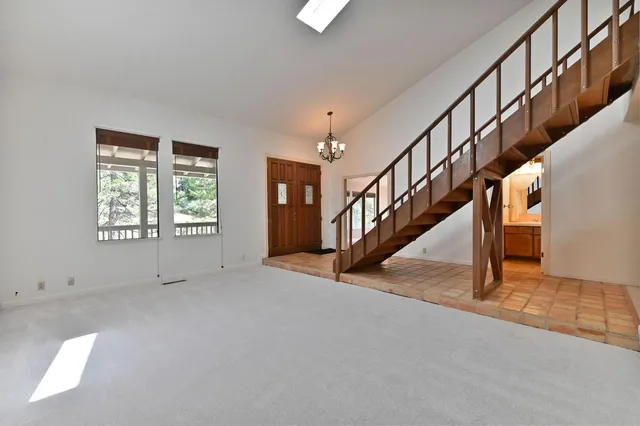 a view of a room with furniture and large window