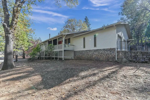 a view of staircase with lots of frames on wall and wooden floor