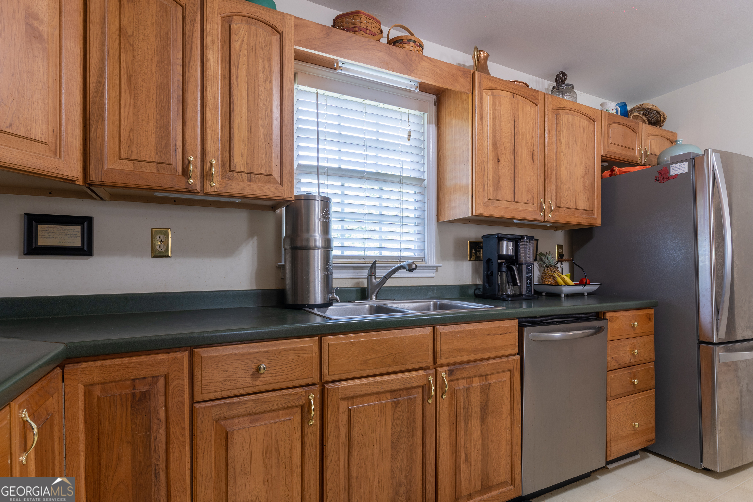1537 Jackson Street Locust Grove, GA 30248 - Photo 18 of 41 a kitchen with granite countertop a sink cabinets and stainless steel appliances