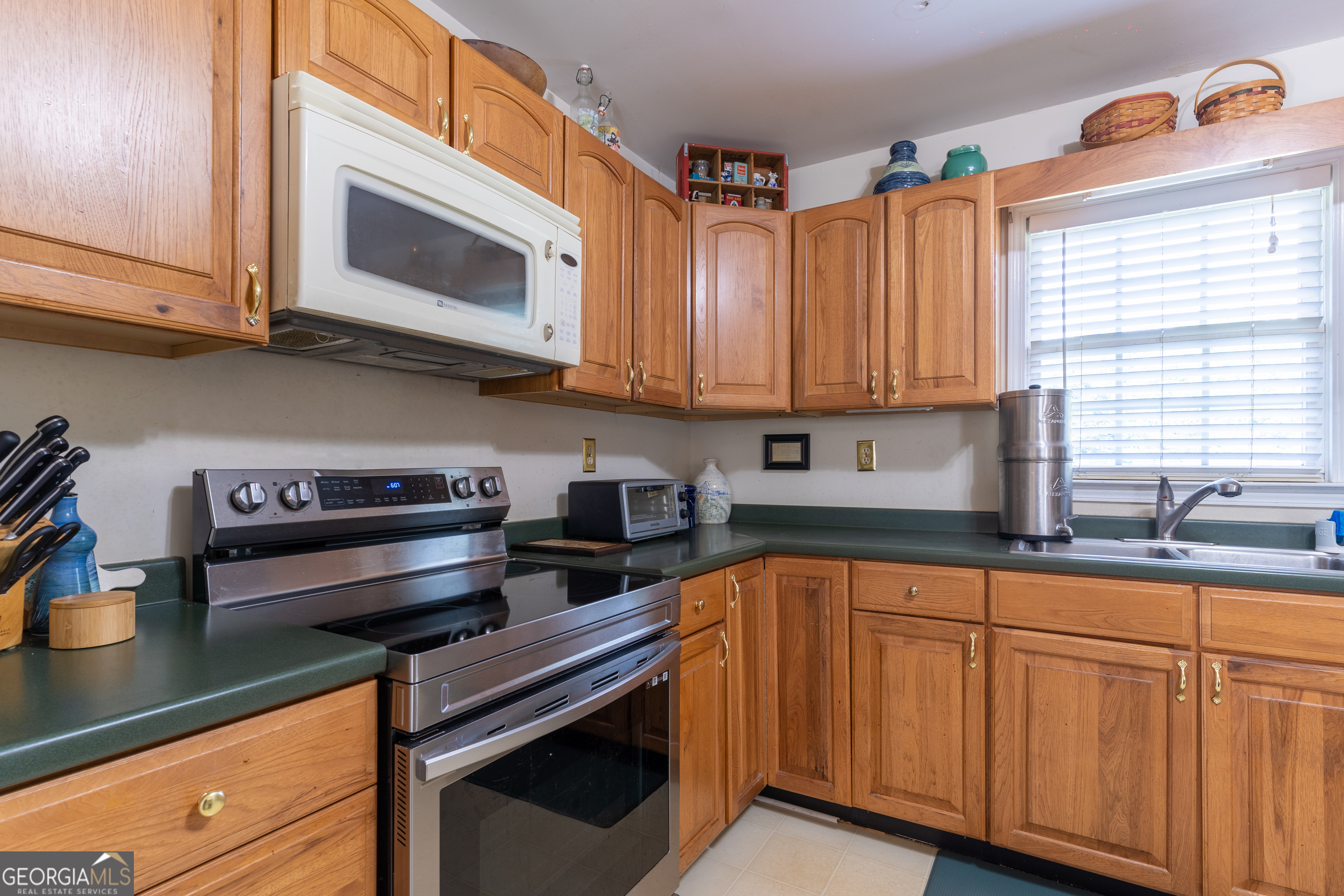1537 Jackson Street Locust Grove, GA 30248 - Photo 19 of 41 a kitchen with stainless steel appliances granite countertop a sink a stove and cabinets
