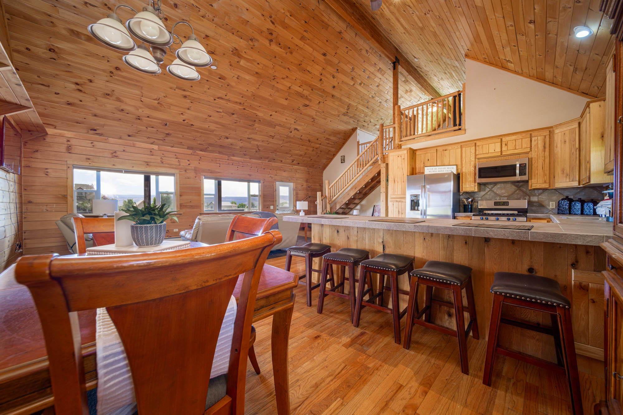 1213 Signal Rock Road Grand Junction, CO 81505 - Photo 12 of 20 a dining hall with stainless steel appliances granite countertop a dining table and chairs with wooden floor