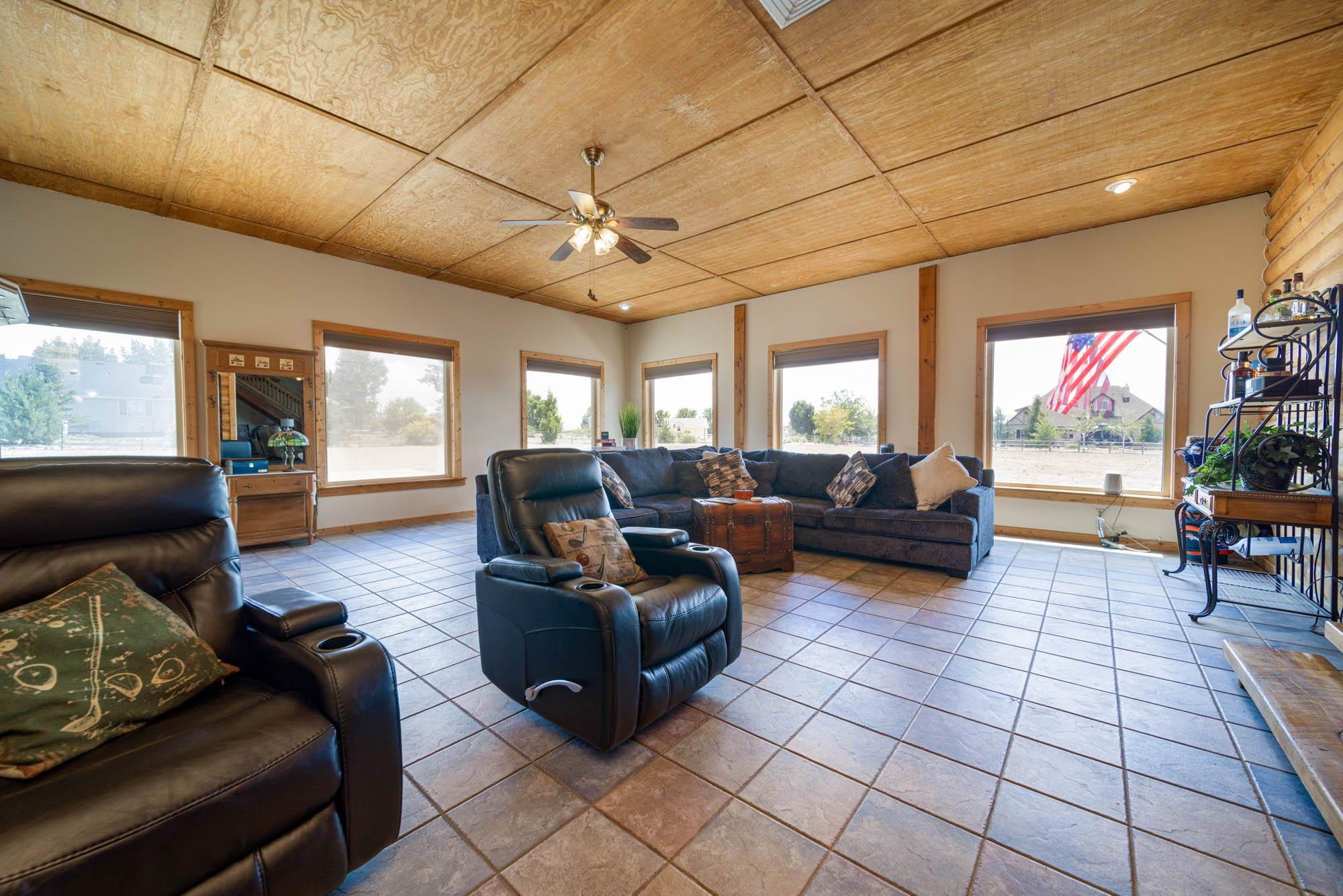1213 Signal Rock Road Grand Junction, CO 81505 - Photo 14 of 20 a living room with furniture and a flat screen tv