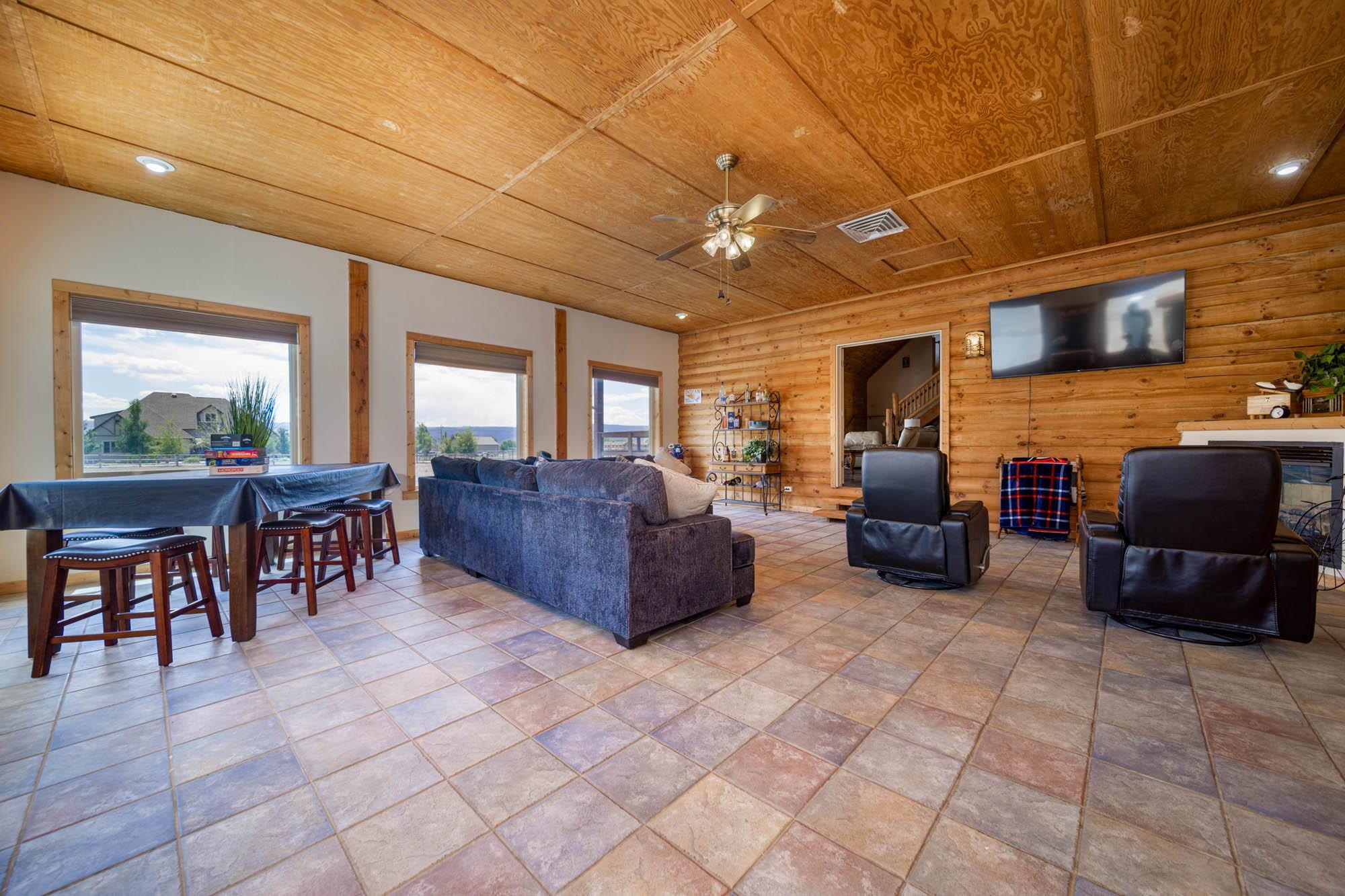 1213 Signal Rock Road Grand Junction, CO 81505 - Photo 15 of 20 a living room with furniture a flat screen tv and kitchen view