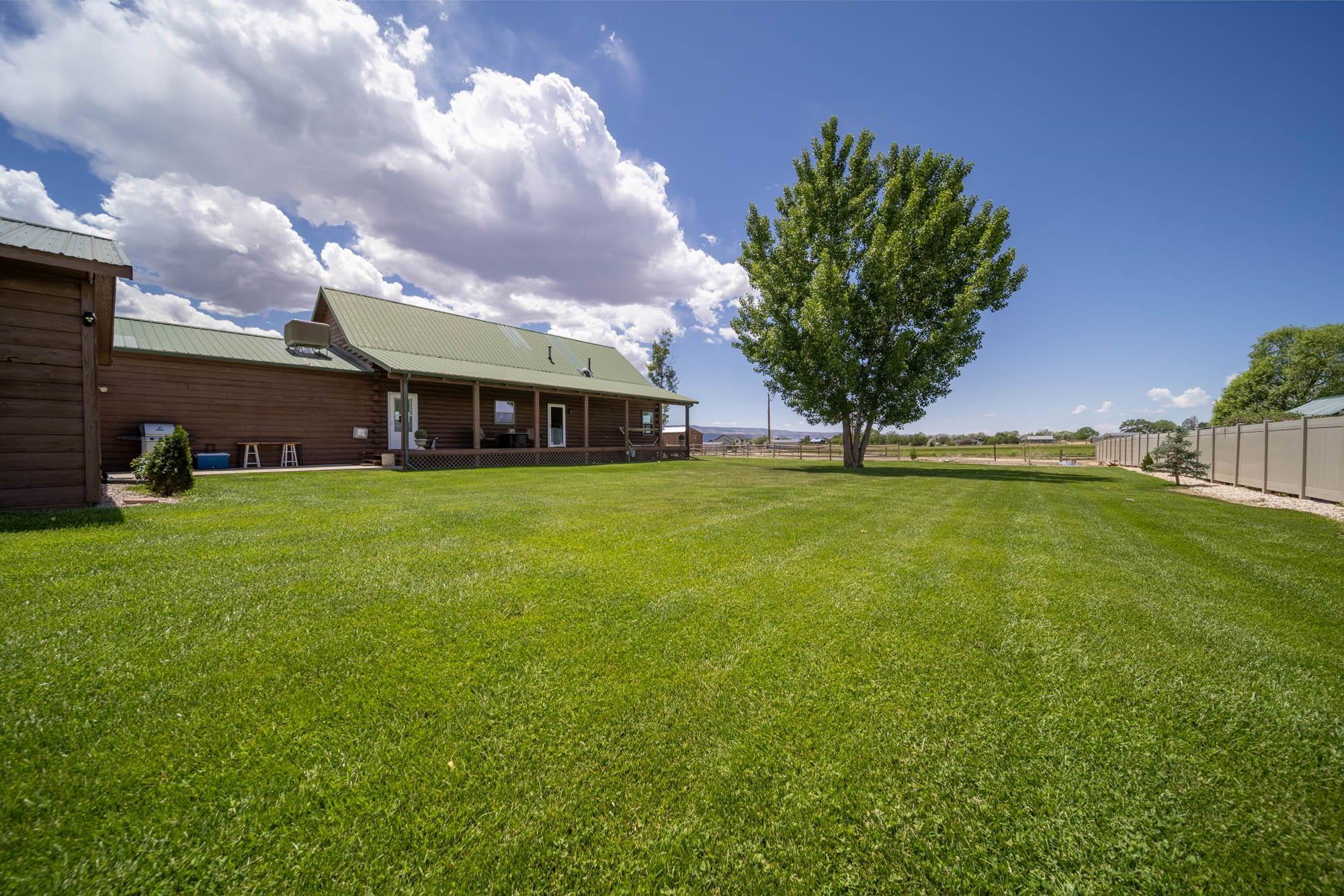 1213 Signal Rock Road Grand Junction, CO 81505 - Photo 8 of 20 a view of a house with a big yard and potted plants