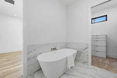 a bathroom with a bathtub and sink