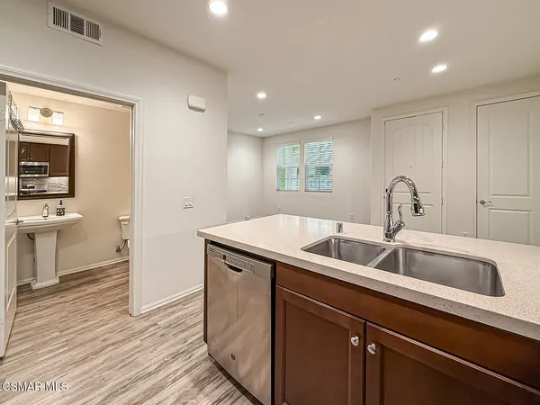 a kitchen with a sink and a refrigerator