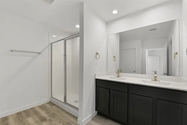 a bathroom with a double vanity sink and a mirror
