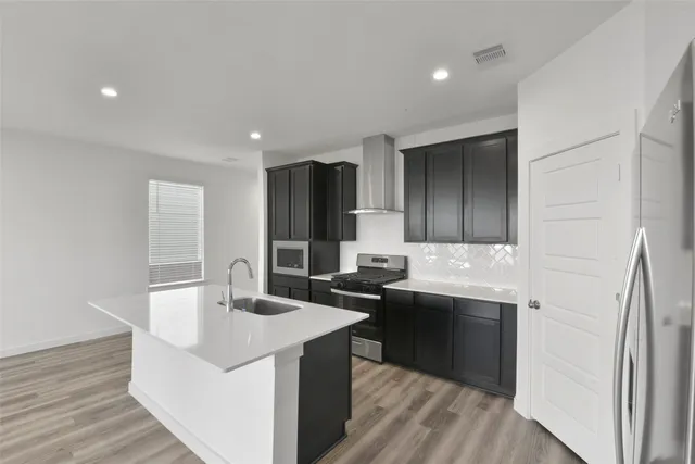 a kitchen with a sink and a refrigerator