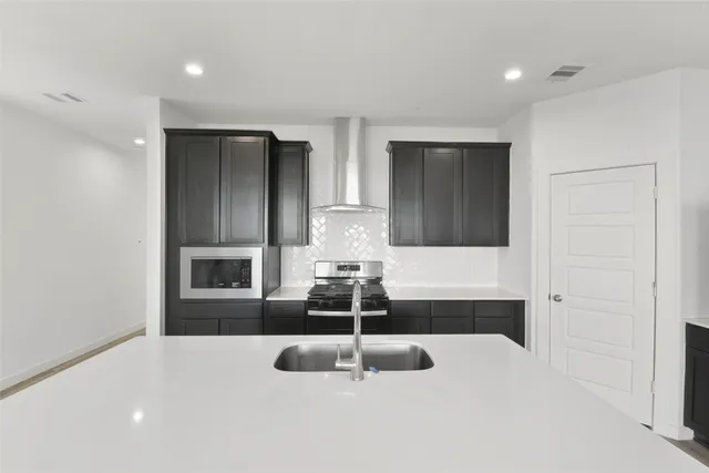 a kitchen with a sink and chandelier
