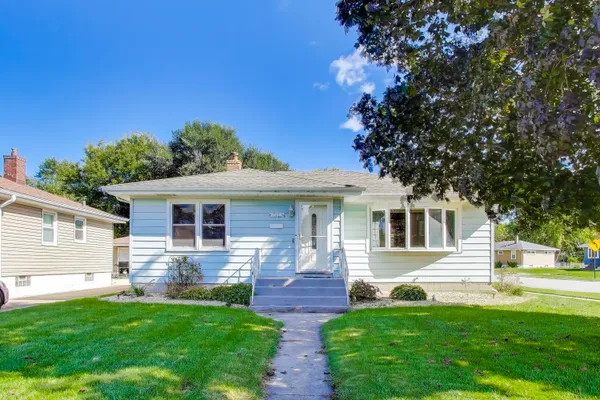 a front view of house with yard and green space
