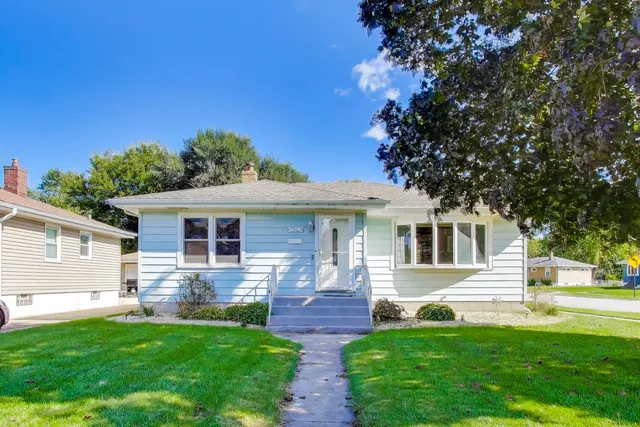 a front view of house with yard and green space