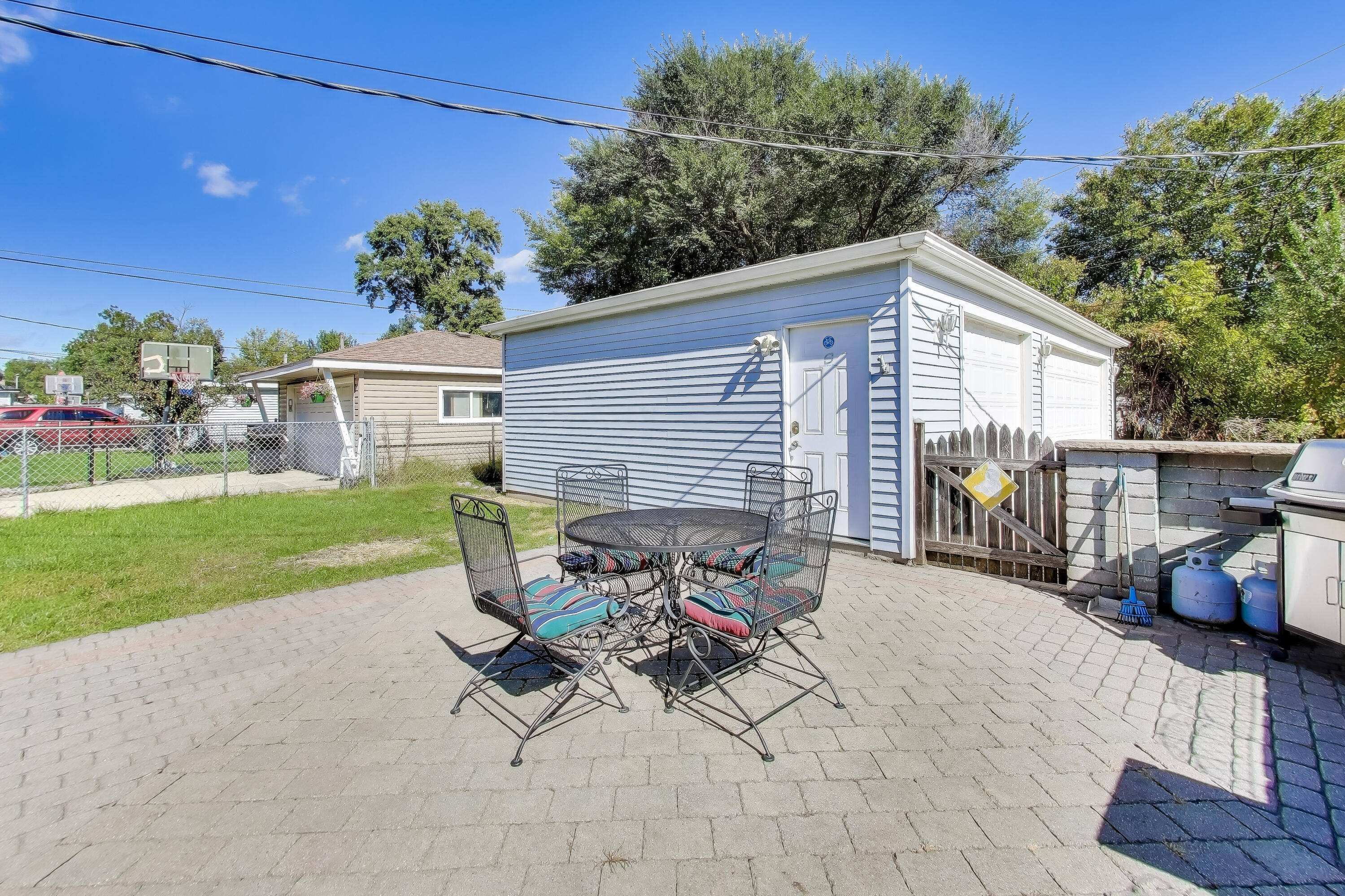1343 Harvey Street Griffith, IN 46319 - Photo 26 of 31 a view of a patio with a dining table and chairs with wooden fence