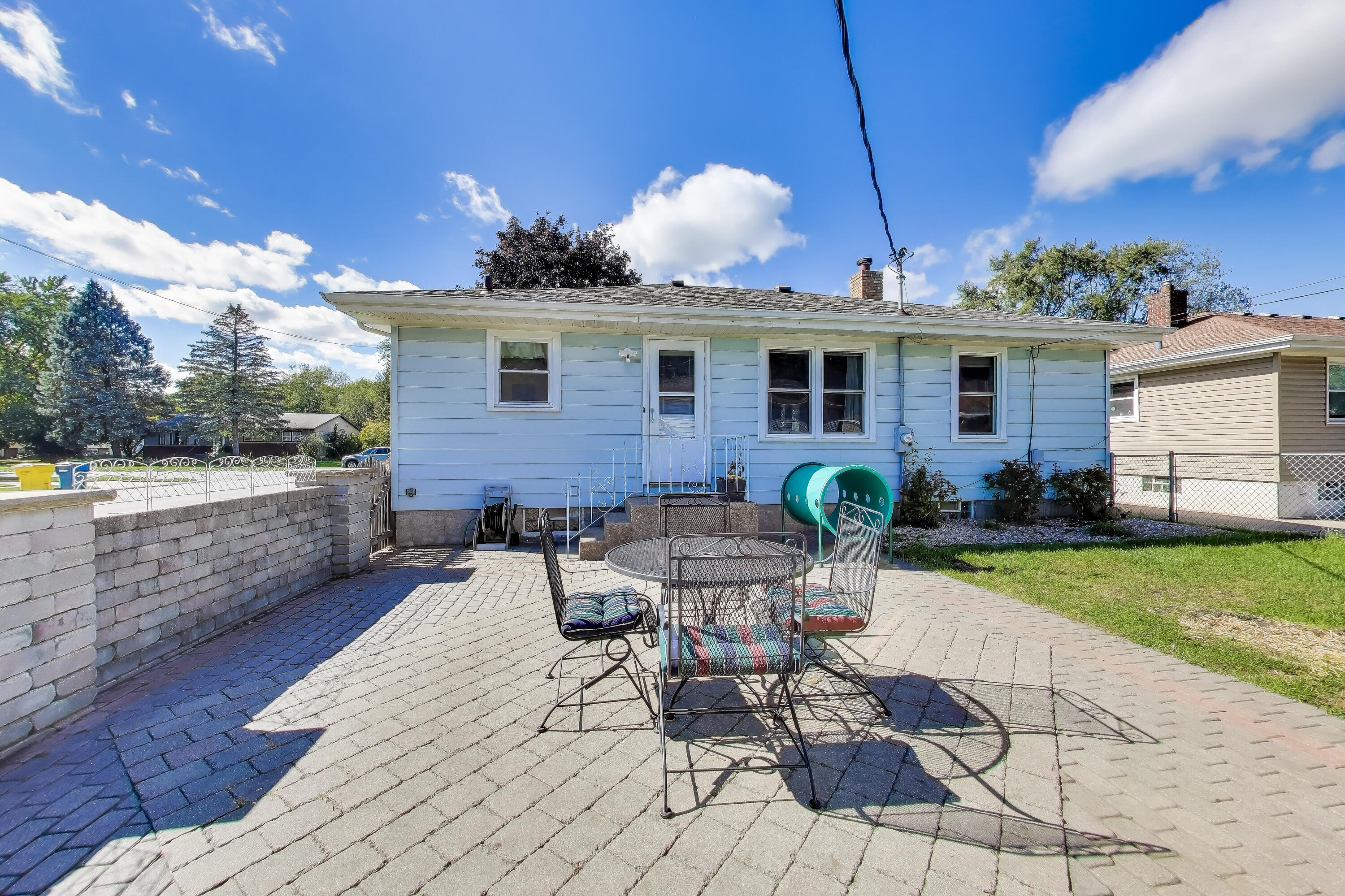 1343 Harvey Street Griffith, IN 46319 - Photo 28 of 31 a view of a patio with table and chairs potted plants with wooden fence