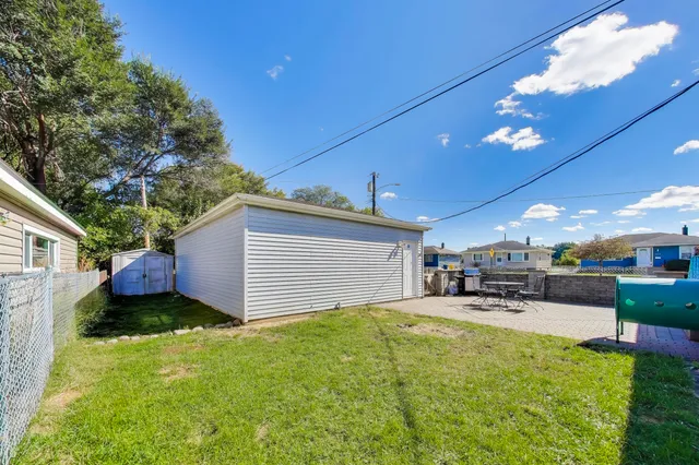 a swimming pool with outdoor seating and yard