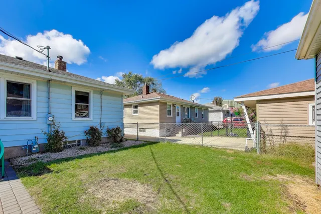 a view of a chair and table in backyard
