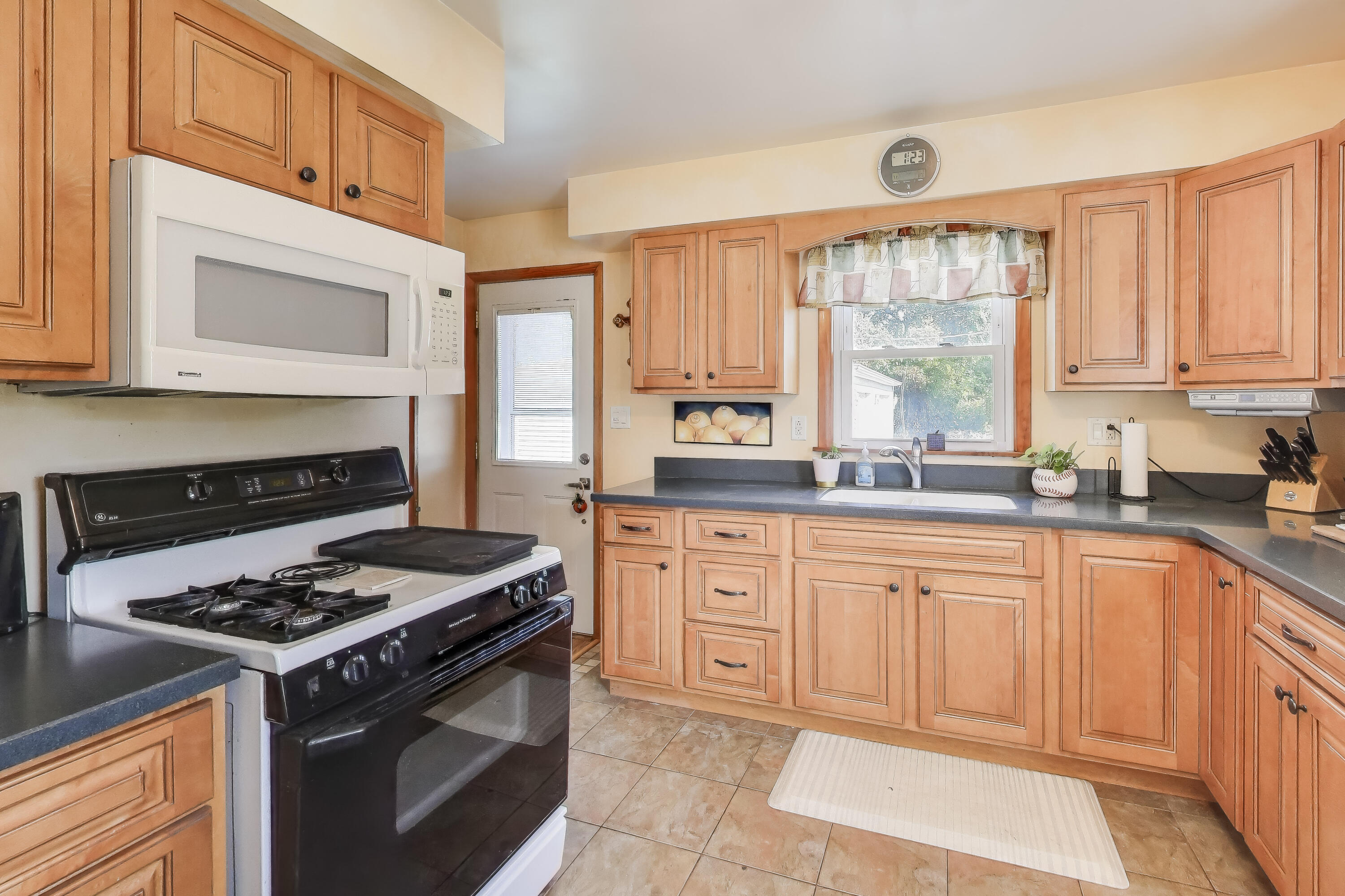 1343 Harvey Street Griffith, IN 46319 - Photo 6 of 31 a kitchen with stainless steel appliances granite countertop a stove a sink and a microwave