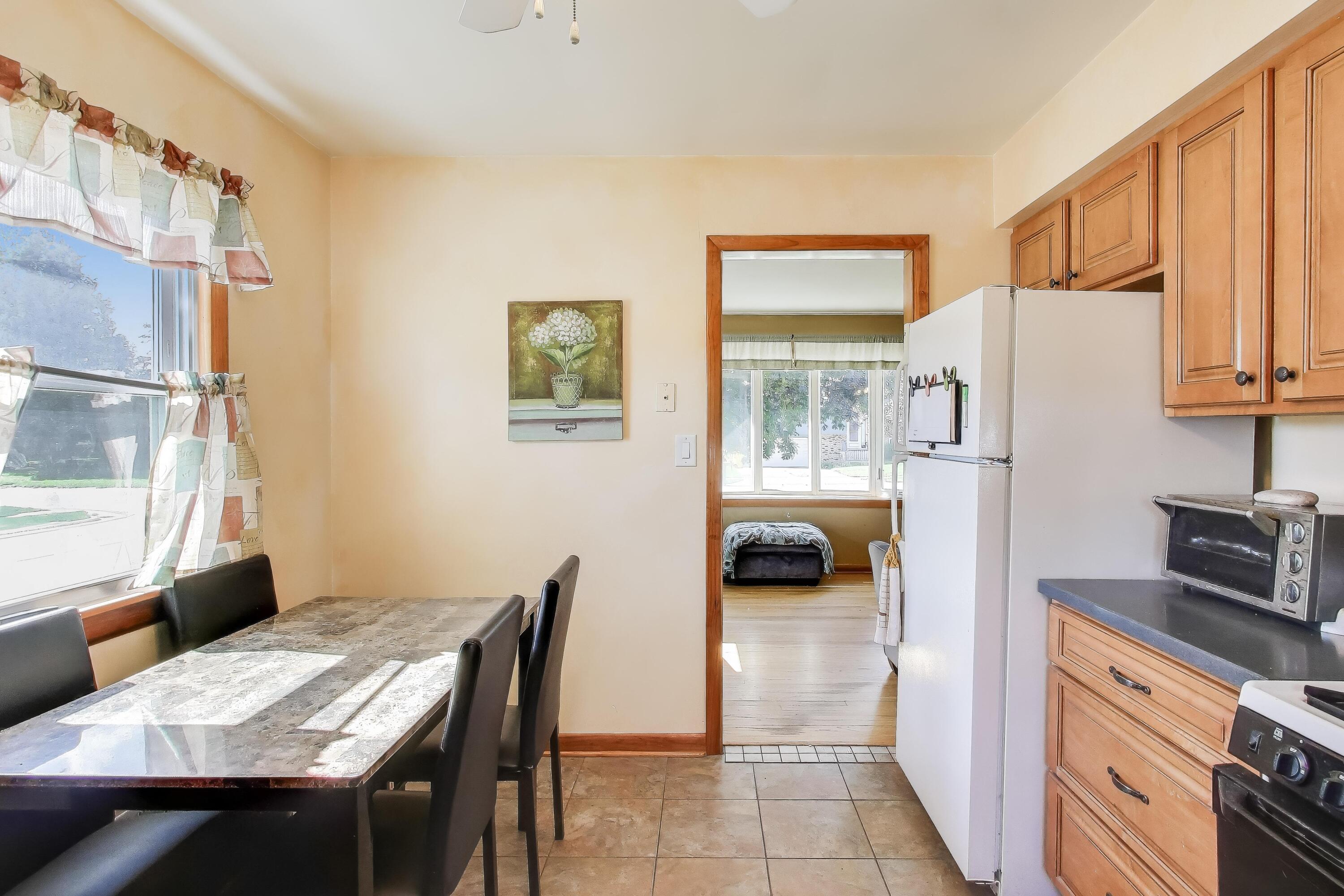 1343 Harvey Street Griffith, IN 46319 - Photo 7 of 31 a kitchen with a table chairs and refrigerator