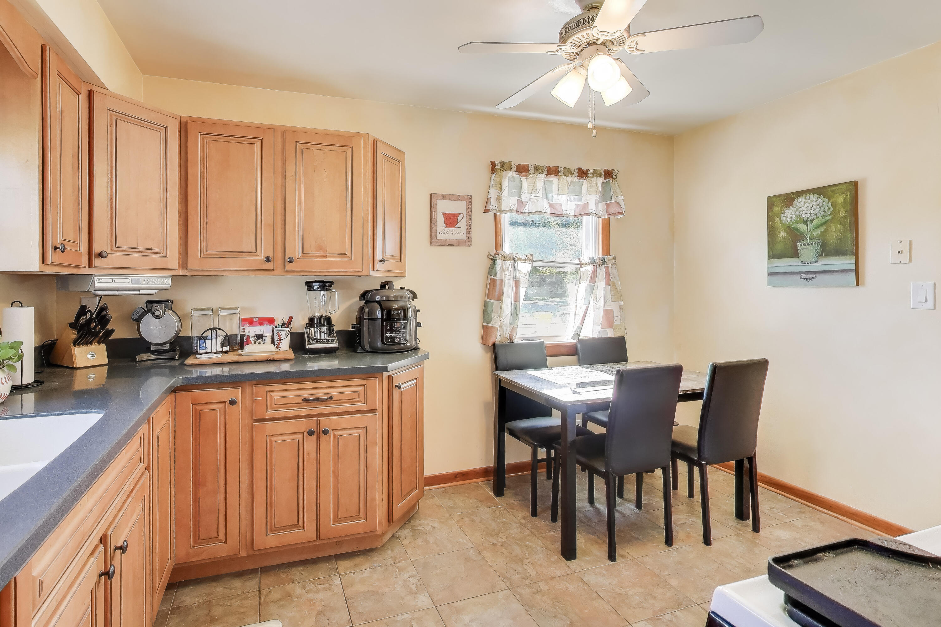 1343 Harvey Street Griffith, IN 46319 - Photo 8 of 31 a kitchen with granite countertop a table chairs sink and cabinets