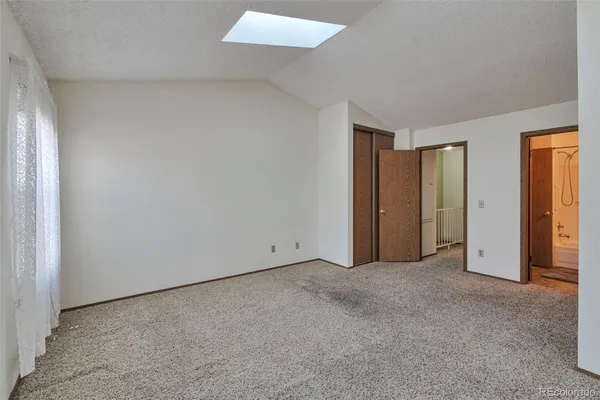 an empty room with closet area