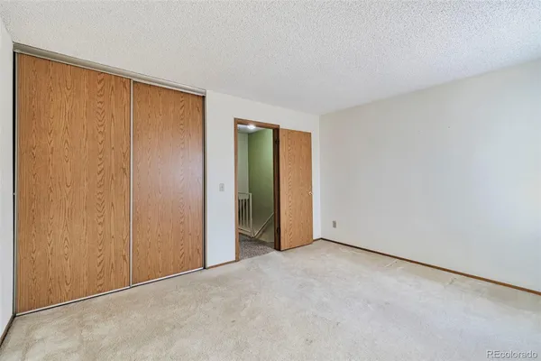 an empty room with closet area