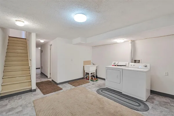 a room with a chair and white walls