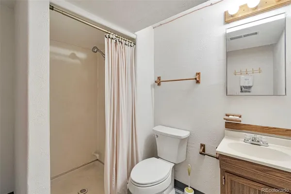 a white toilet sitting next to a bathroom sink